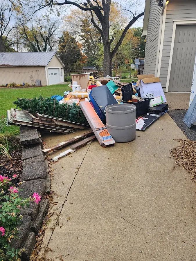 Dumpster being loaded with debris for Residential Dumpster Rental in South Harrison